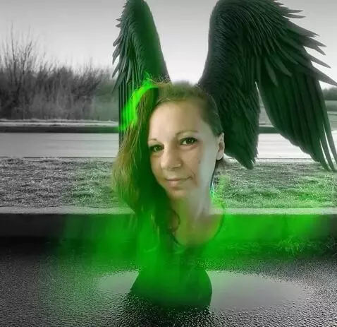 AI Video from prompt: a woman with wings sitting on the side of a road