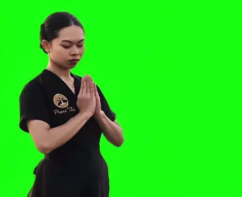 AI Video from prompt: The Thai girl bows slowly and carefully with her