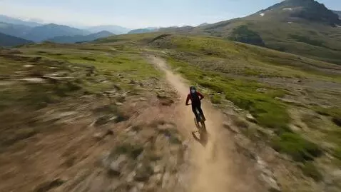 AI Video from prompt: POV downhill mountain bike riding a mountain tra
