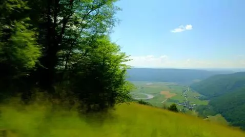 AI Video from prompt: Photorealistic view from a high hill on a clear 