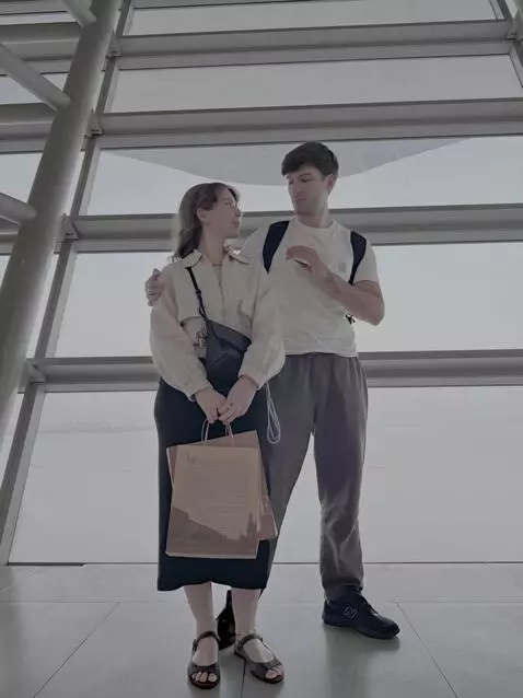 AI Video from prompt: A loving couple stand together inside a sleek, f
