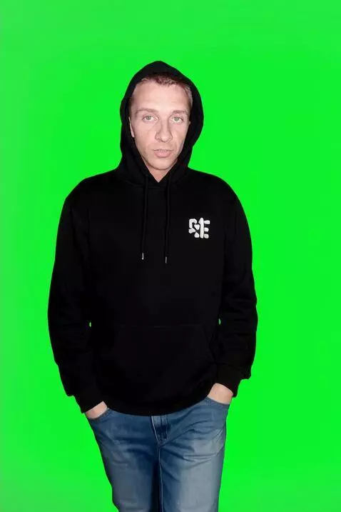 AI Video from prompt: Without taking his eyes off the camera, the youn