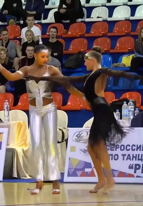 AI Video from prompt: a girl in a silver shiny Latin American short su