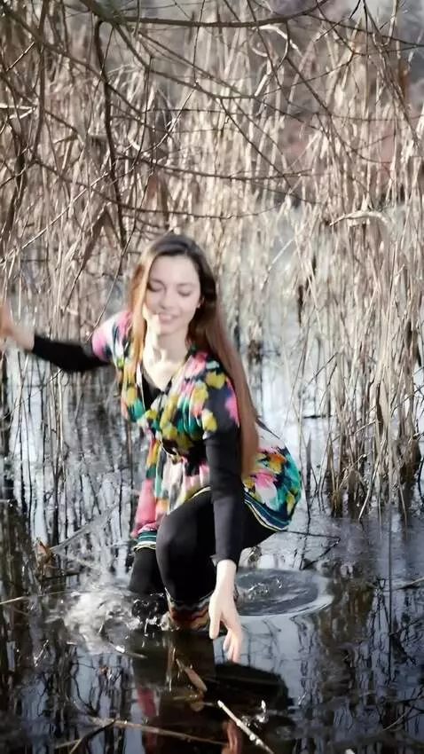 AI Video from prompt: The girl squato down and pulls a large moray eel