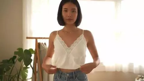 AI Video from prompt: The girl changed her T-shirt for a white lace ta