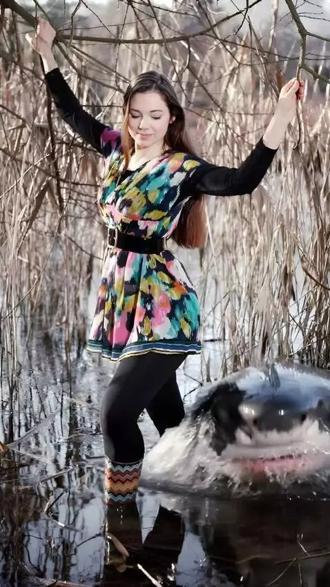 AI Video from prompt: a girl a large shark out of the water