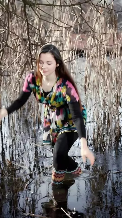 AI Video from prompt: a girl quicky grabs a large python from the wate