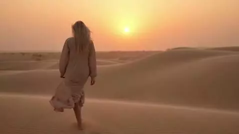 AI Video from prompt: A slender blonde with long hair walks through th