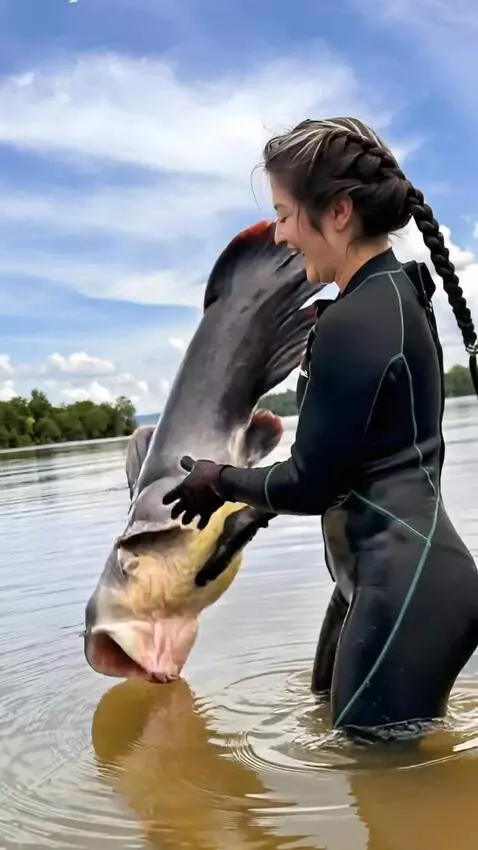 AI Video from prompt: the girl releases the catfish, but the crocodile