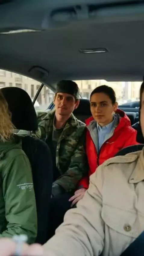 AI Video from prompt: People in the photo are driving in a car through