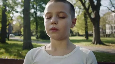 AI Video from prompt: A person sitting on a park bench takes a deep br