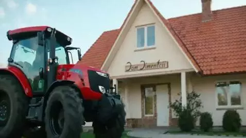 AI Video from prompt: Hes driving a tractor and hes driving it at a ho