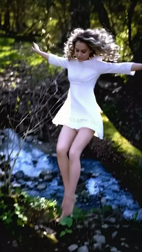 AI Video from prompt: A woman  jumps from a log into the water and cat