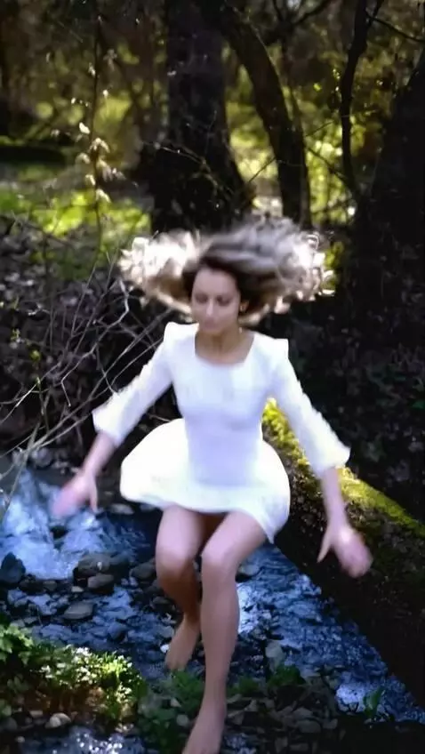 AI Video from prompt: A woman  jumps from a log into the water and cat