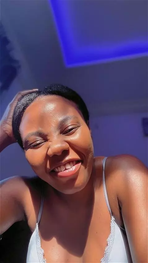 AI Video from prompt: Smiling and giggling to a funny joke for about 2