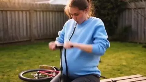 AI Video from prompt: The girl brought a bicycle pump and put the pump