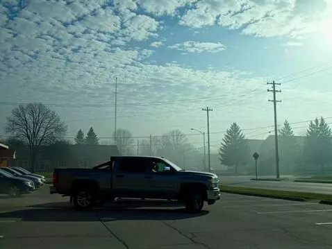 AI Video from prompt: Two pickup trucks, one gray and one black, slowl