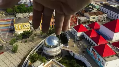 AI Video from prompt: A cinematic aerial view of a real city. Suddenly