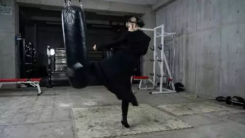 AI Video from prompt: Japanese girl in heels, wearing a black trench c