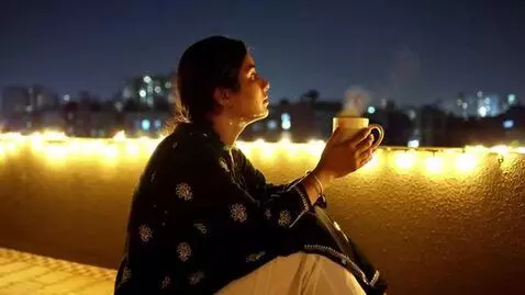 AI Video from prompt: dreaming alone sitting with a coffee mug in the 