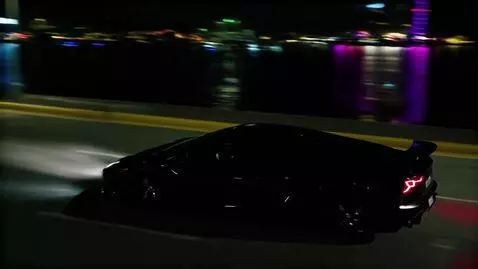 AI Video from prompt: A cinematic night scene in Dubai. A sleek black 
