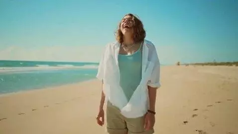 AI Video from prompt: a woman's chest expands quickly on a beach,  com