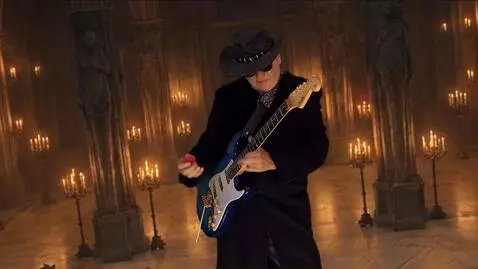 AI Video from prompt: the guitarist dramatically plays the solo in the