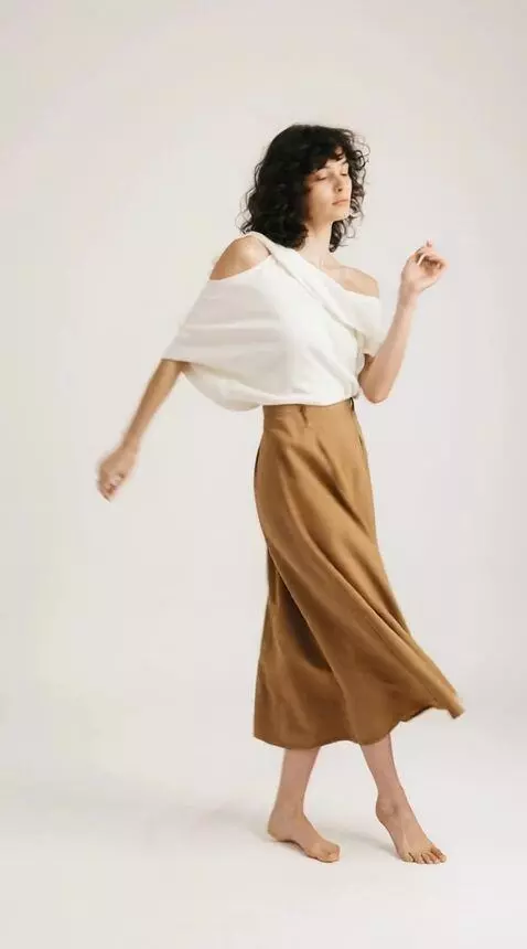 AI Video from prompt: A woman dances a fast dance in a completely whit