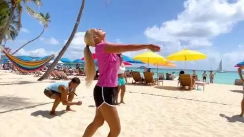 AI Video from prompt: A woman with long blond hair, wearing a pink T-s