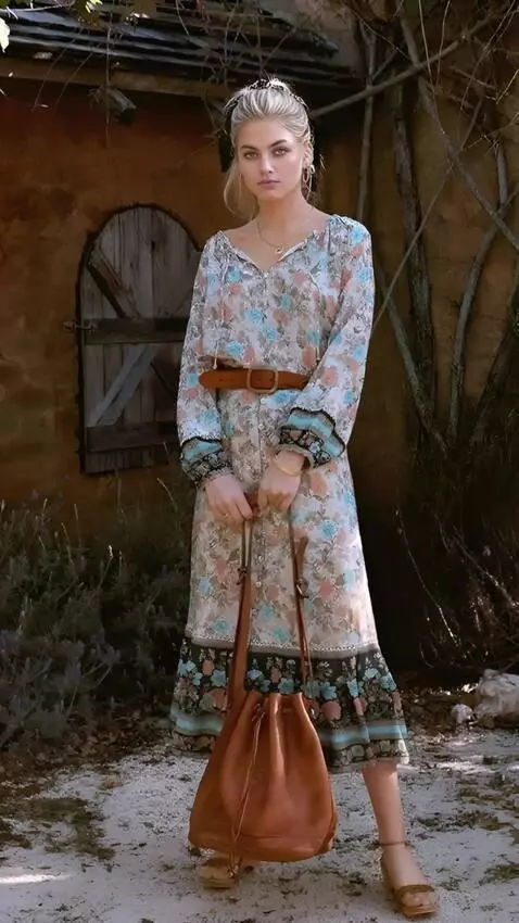 AI Video from prompt: A woman stands in front stump,holding a large ax