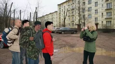 AI Video from prompt: A girl films men on camera. The men pose.