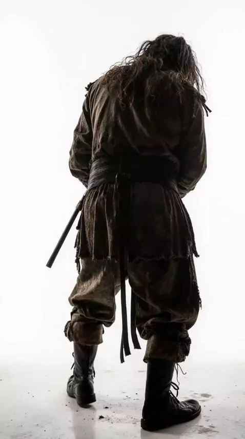 AI Video from prompt: The man, hunched over, walks slowly, moving away