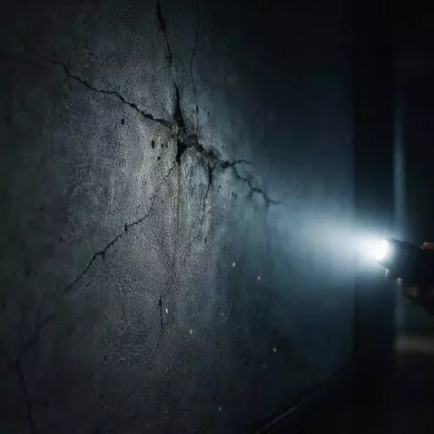 AI Video from prompt: cinematic horror close-up of cracked wall in dar