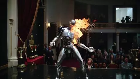 AI Video from prompt: An advanced dancing robot, on fire on a big movi