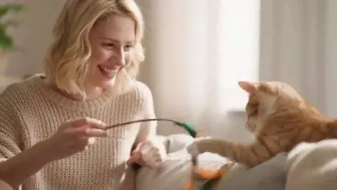 AI Video from prompt: Blonde woman play with her kitty