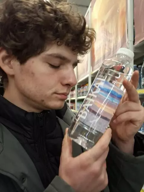 AI Video from prompt: a guy licks a water bottle and then ends up on t