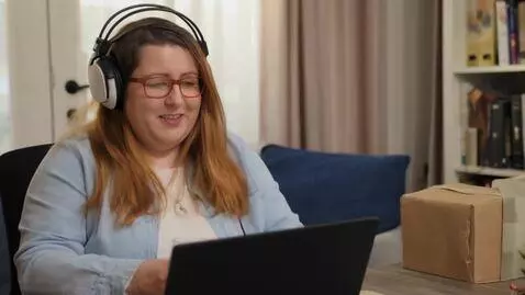 AI Video from prompt: streamer woman at a computer becomes massively f