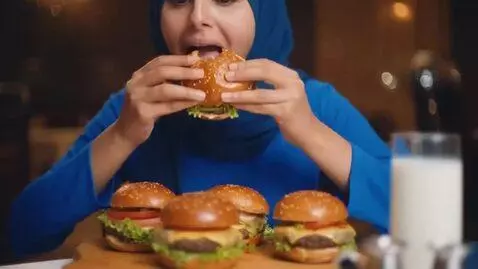 AI Video from prompt: Have her wear a blue dress, sitting alone in a f