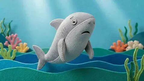 AI Video from prompt: 3D sewn-felt stop-motion style. The cartoon shar