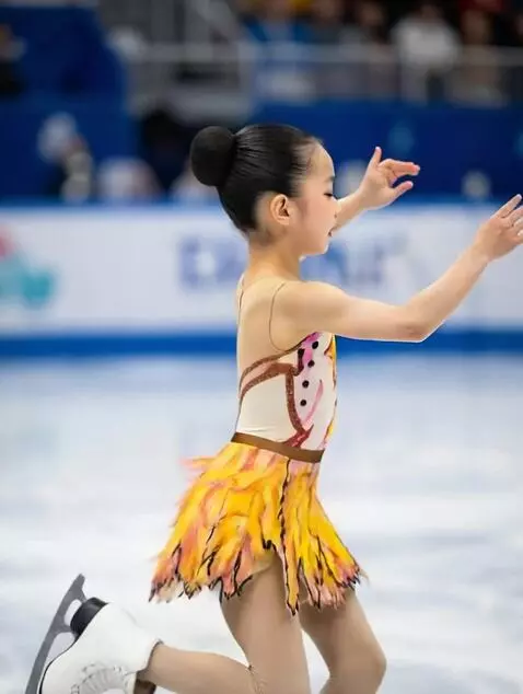 AI Video from prompt: A figure skater girl performs a quadruple jump a