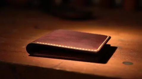 AI Video from prompt: [STYLE BASE] + The finished leather piece — a bi