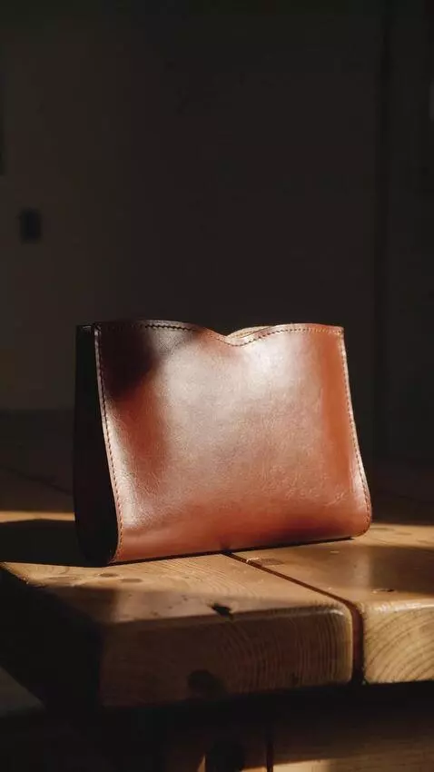 AI Video from prompt: [STYLE BASE] + The finished leather piece — a bi