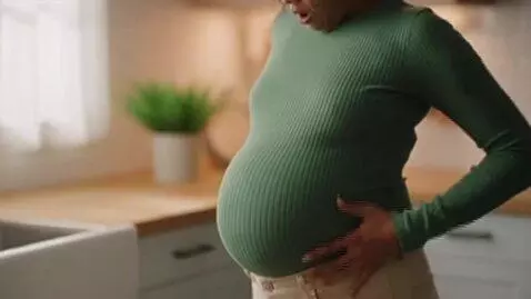 AI Video from prompt: womans stomach inflates