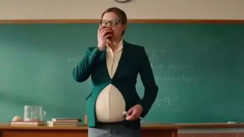 AI Video from prompt: a woman professor in a classroom, becomes hugely