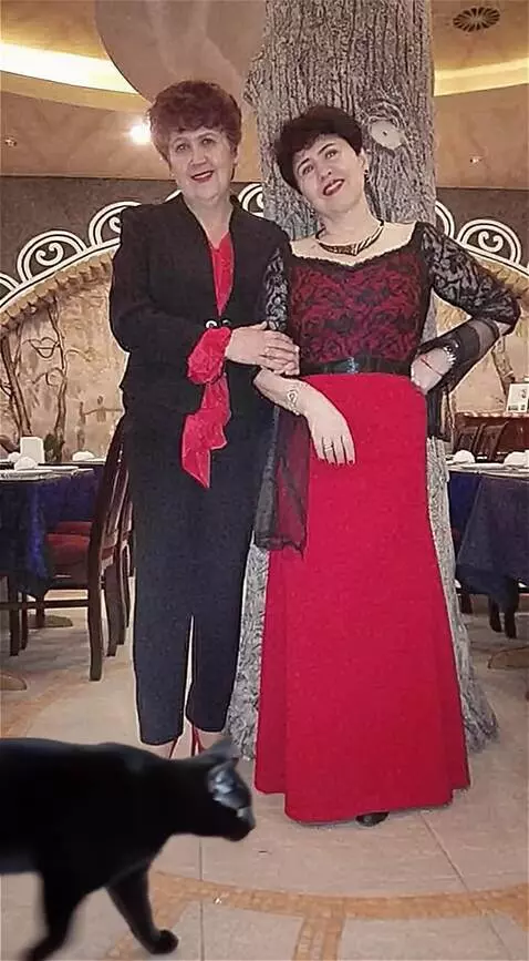 AI Video from prompt: A black cat walked between the women