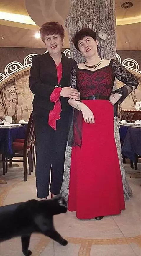 AI Video from prompt: A black cat walked between the women's legs