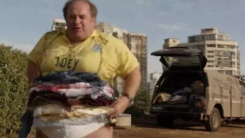 AI Video from prompt: a thin man is wearing the most clothes anyone ha