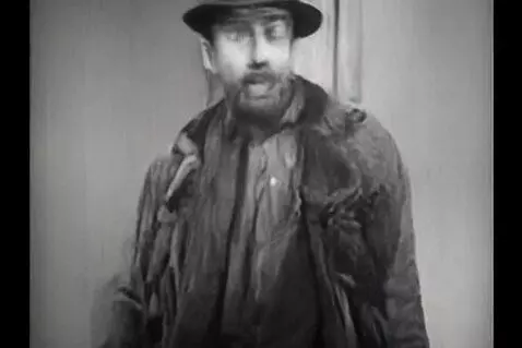 AI Video from prompt: a thin man is wearing the most clothes anyone ha