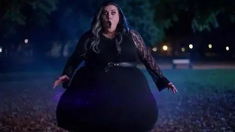 AI Video from prompt: a slim goth woman magically becomes enormously d