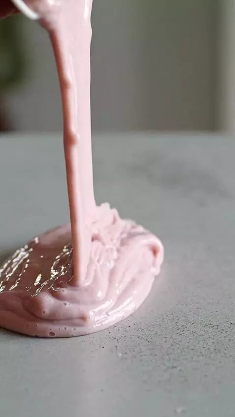 AI Video from prompt: Generate a video of a pink yoghurt spill from on